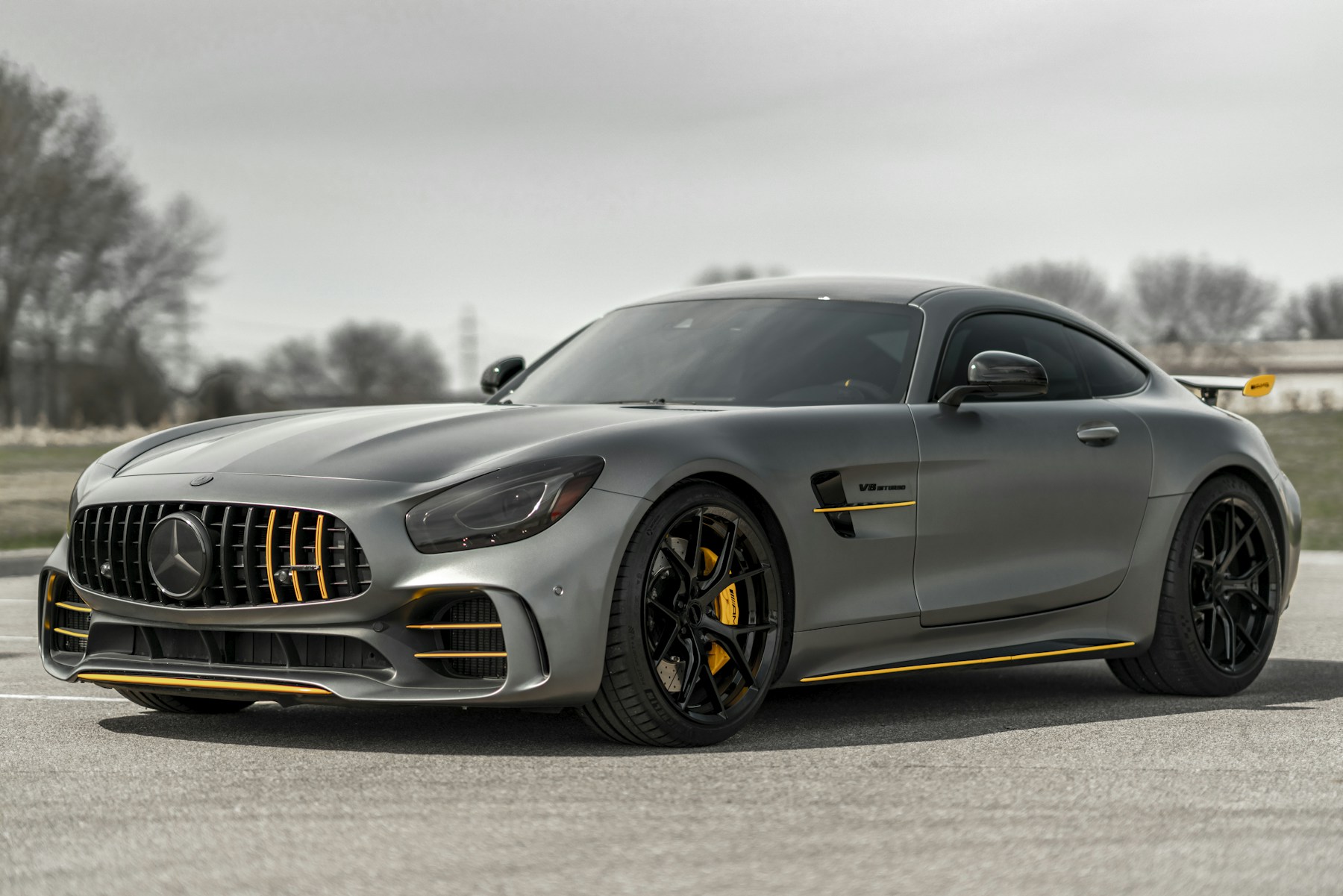 Silver sports car with yellow accents; illustrative reference photograph